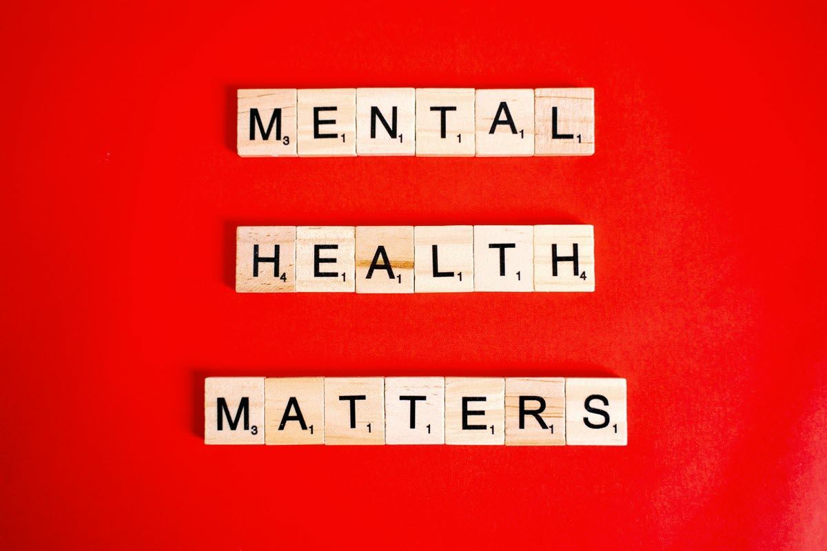 Scrabble tiles on red background spell “MENTAL HEALTH MATTERS.”