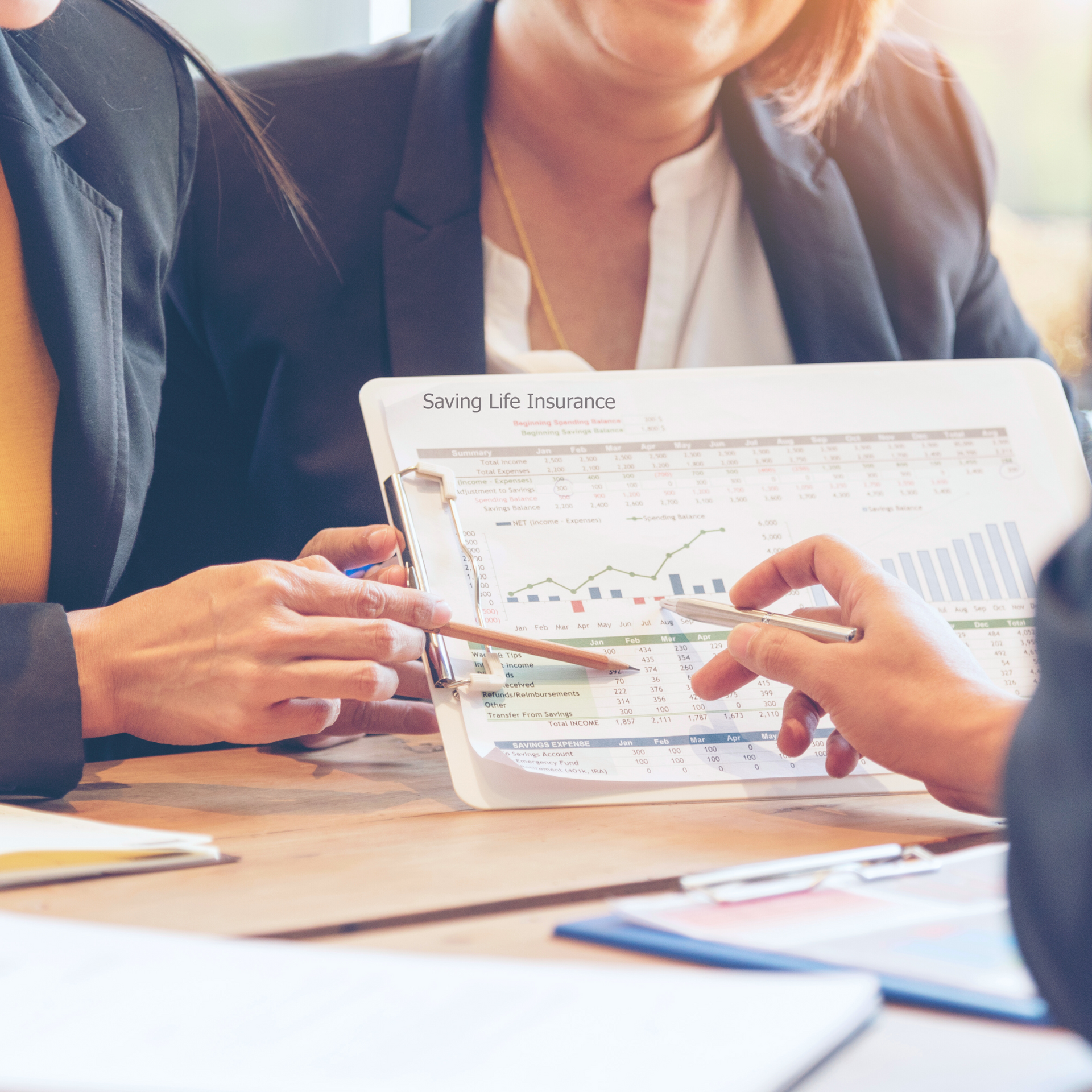A man and a woman are sitting at a table looking at a piece of paper.