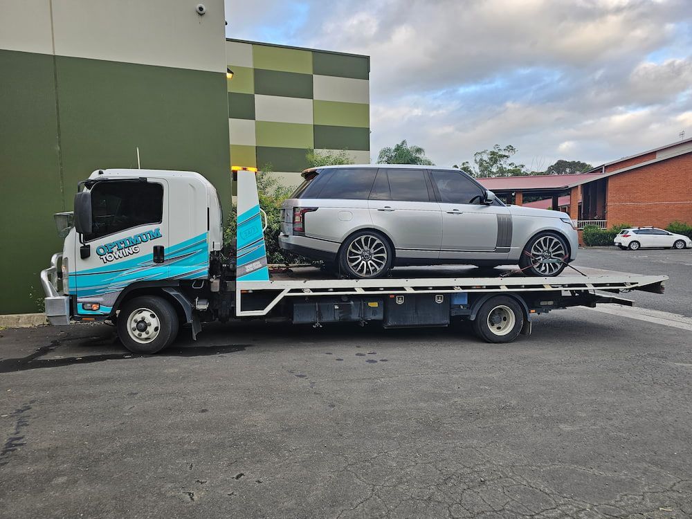 Broken Red Car And Tow Truck — Optimum Towing in Kiama, NSW
