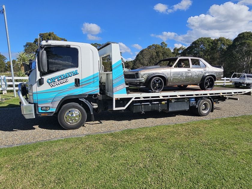 A Tow Truck With a Car on the Back of It — Optimum Towing in Nowra, NSW