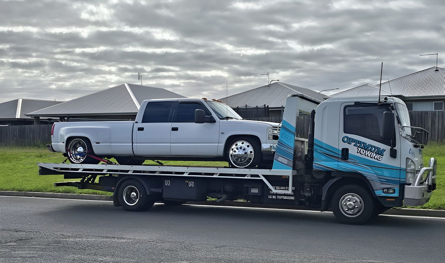 White Pickup Truck Being Towed on a Flatbed Tow Truck