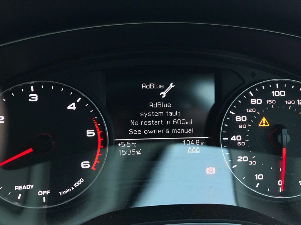 A close up of a car dashboard shows the time as 11:53