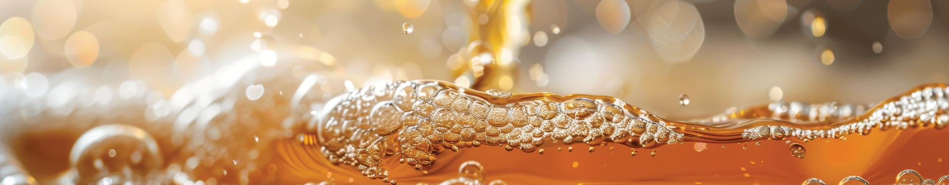 A glass of beer is being poured from a tap.