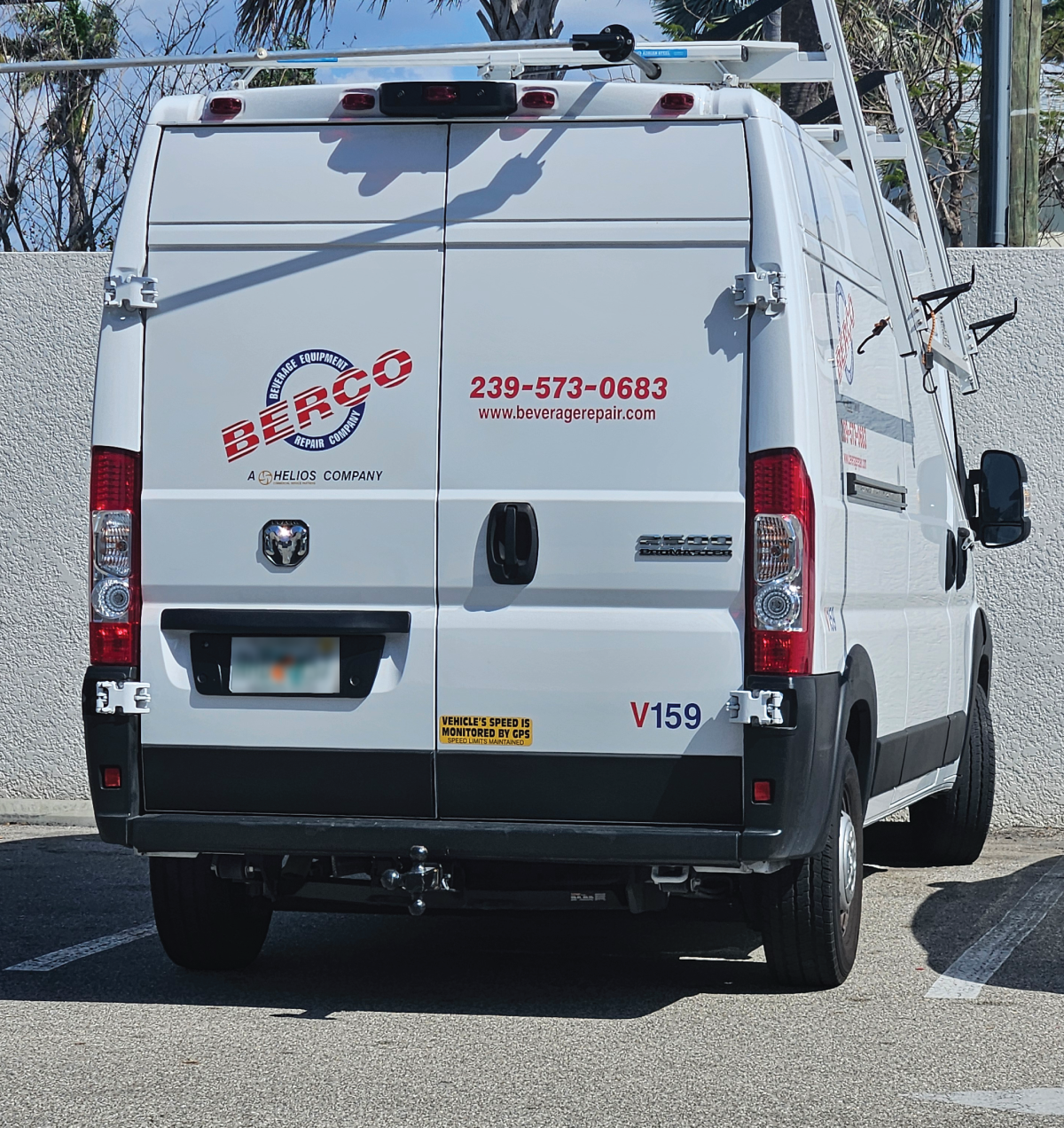 A white van with a phone number on the back