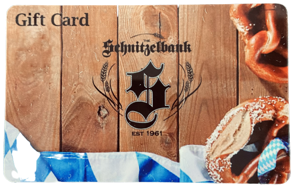 Gift card with Schnitzelbank logo on wood background, framed by blue ribbon and pretzel