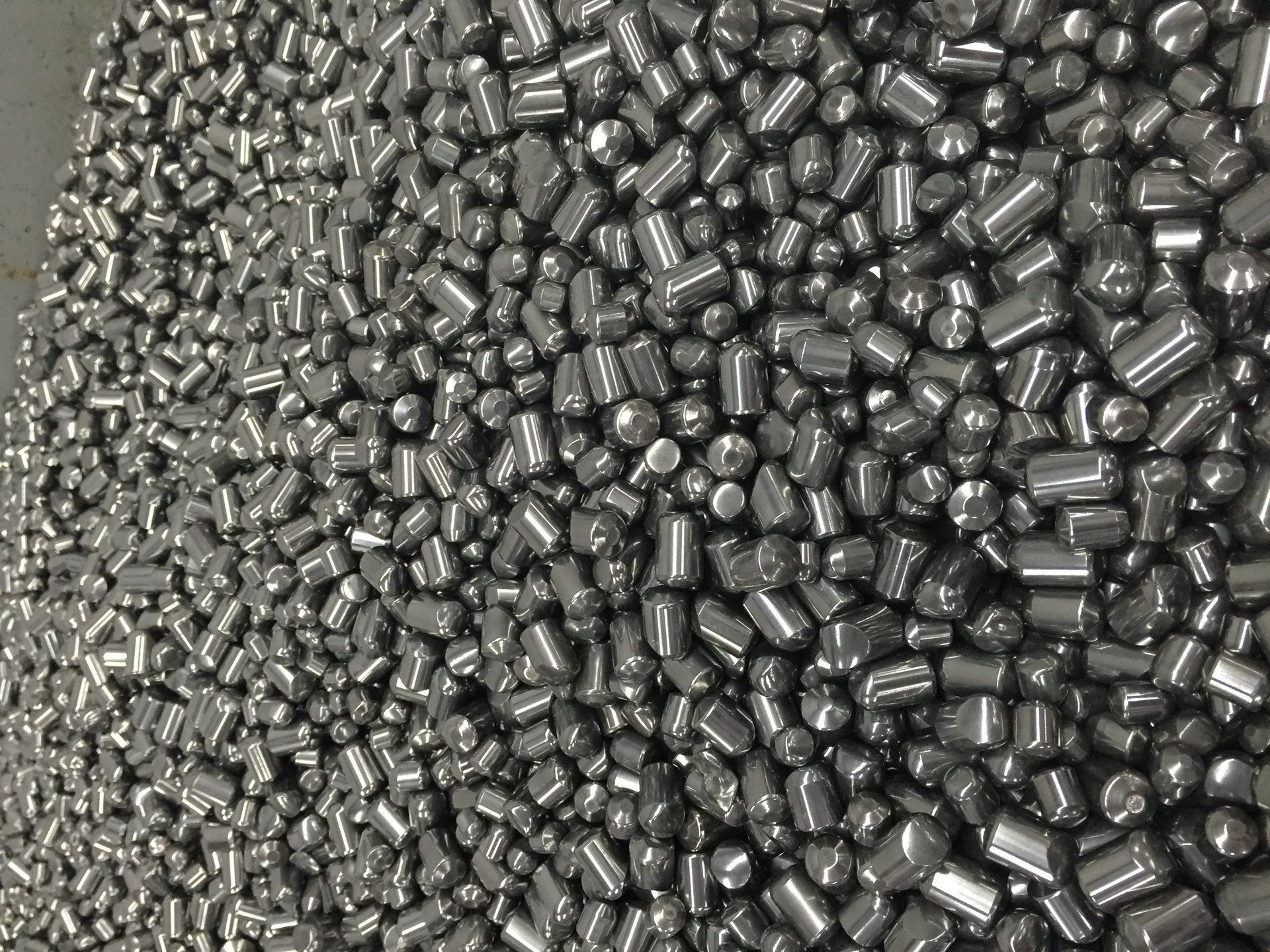 A pile of metal balls sitting on top of each other on a table.