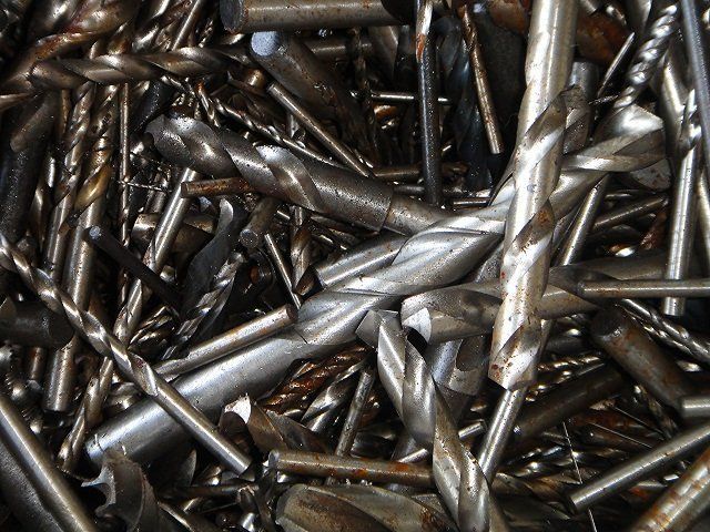 A pile of drill bits are stacked on top of each other