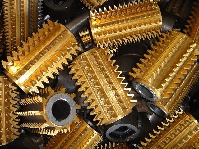 A bunch of gold gears are stacked on top of each other