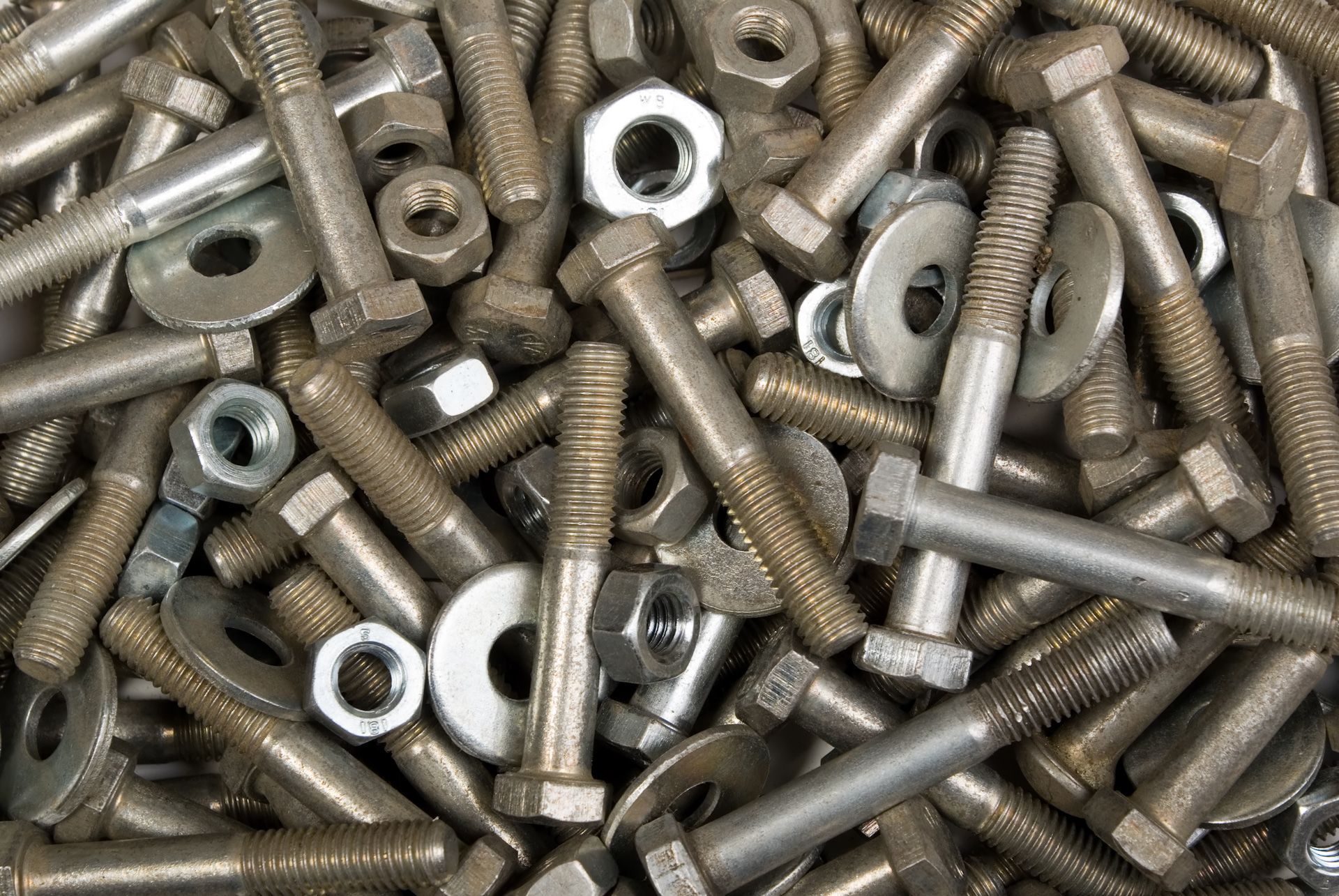 A pile of nuts and bolts on a table.