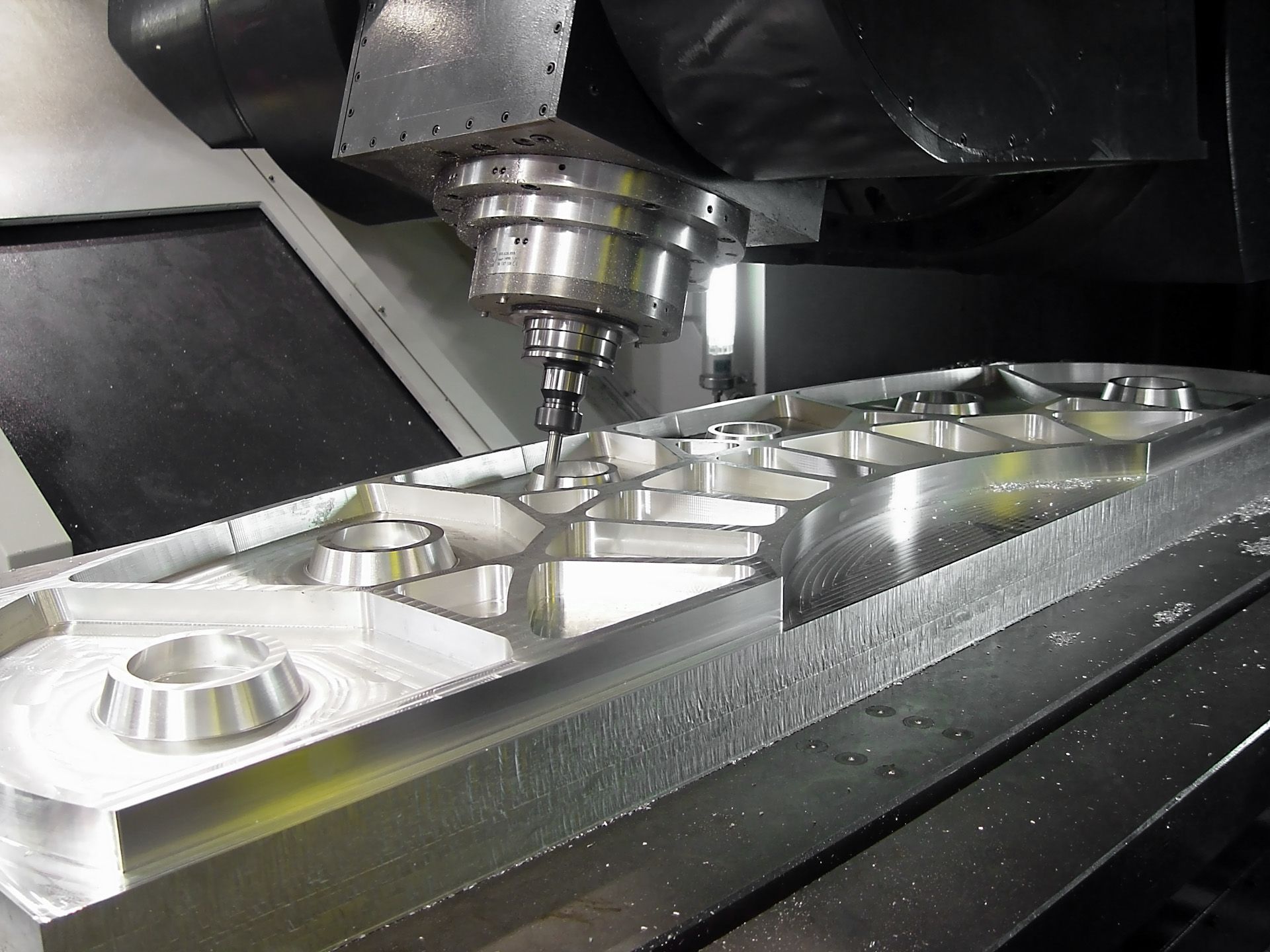 A machine is cutting a piece of metal in a factory
