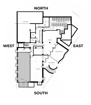 Floor plan of a building, oriented with compass directions. Features rooms and pathways, showing layout and structure.