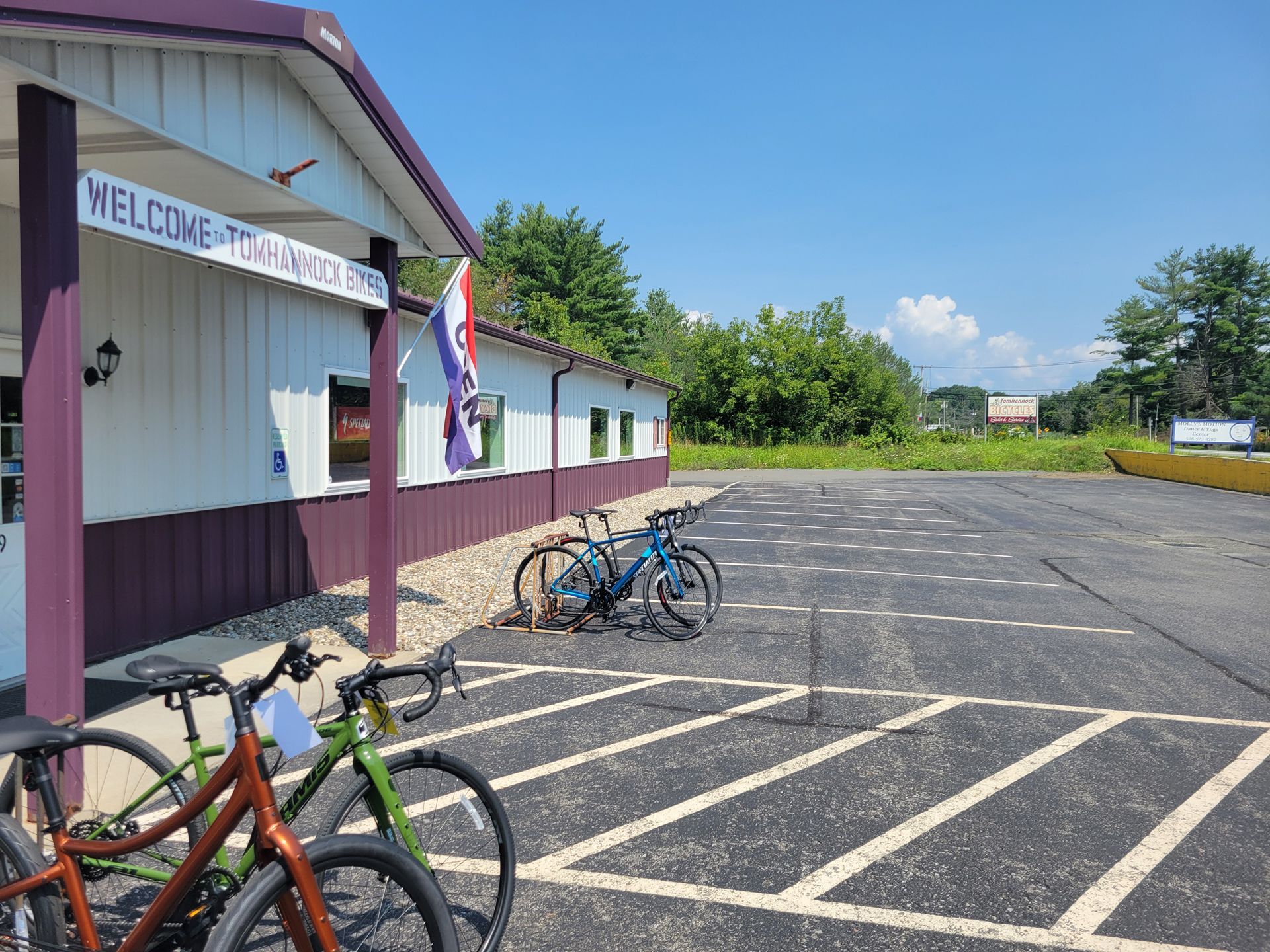 A Row of Bicycles Are Parked in a Parking Lot in Front of a Building