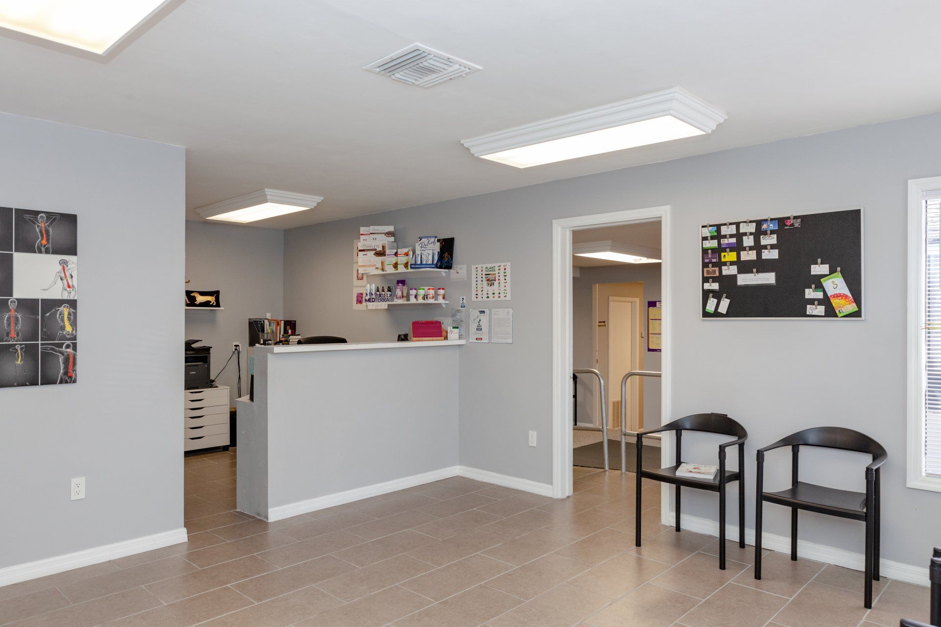 A waiting room with chairs and a counter in a building