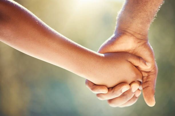 A Man and a Child are Holding Hands — Alexander Law Firm in ST Pickens
