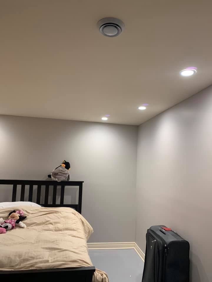 A bedroom with a bed and a suitcase in it.