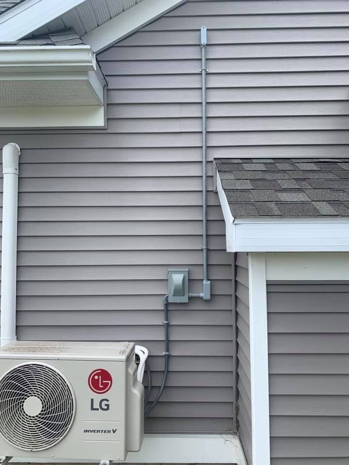 An lg air conditioner is installed on the side of a house.