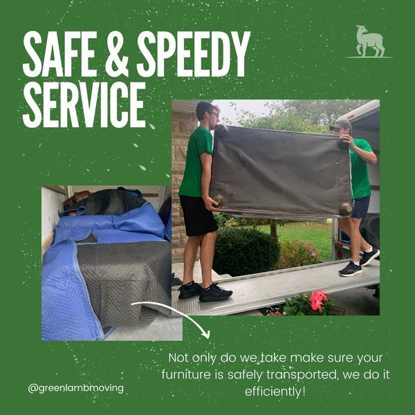 A man in a green shirt is carrying a large piece of furniture