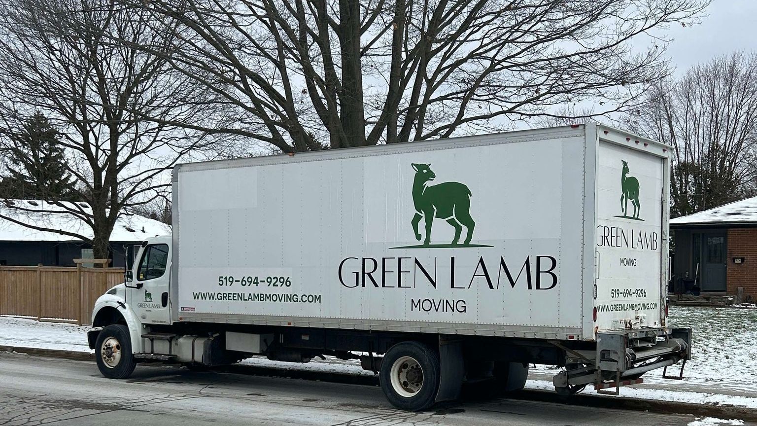 A green lamb truck is parked on the side of the road