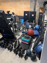 A gym filled with lots of exercise equipment and dumbbells.