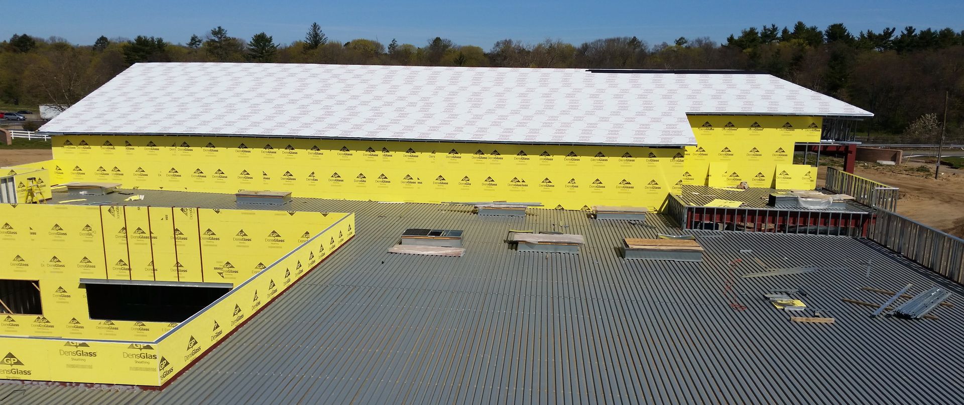 The roof of a building with a city skyline in the background.