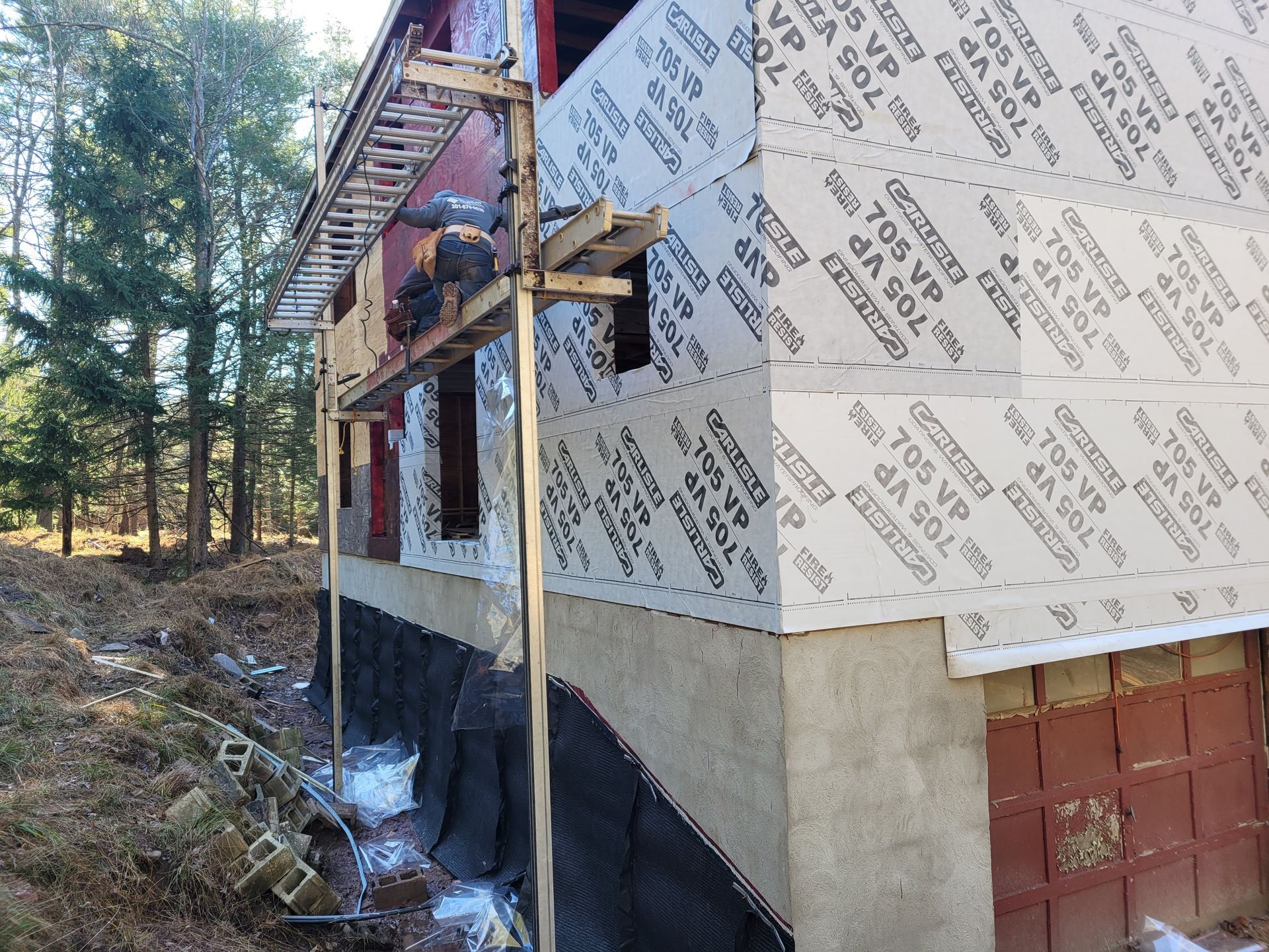 A man is working on a roof with a torch.