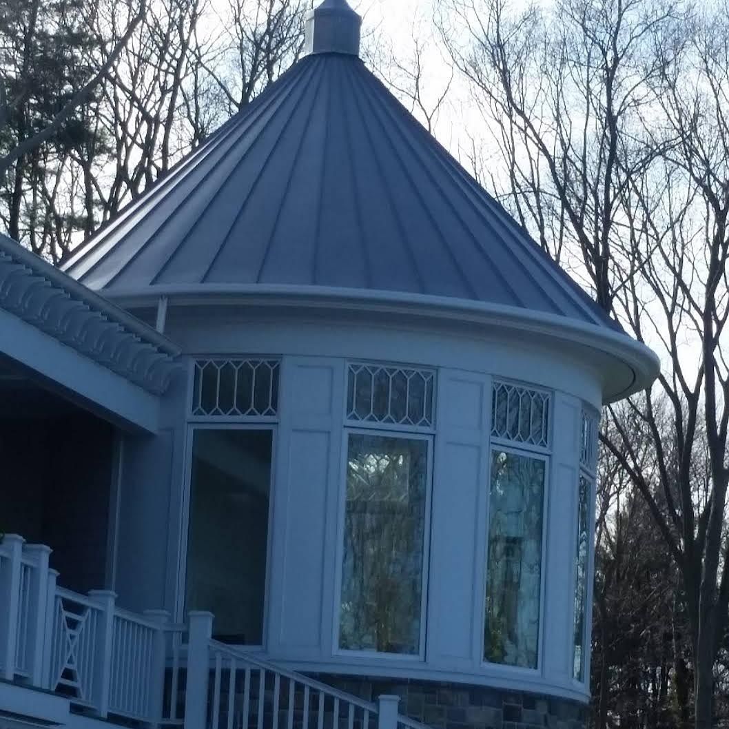 The roof of a brick building has a metal roof