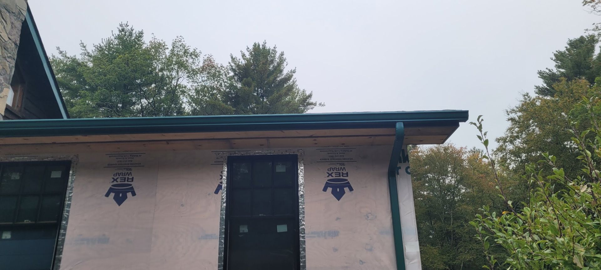 A gutter is attached to the side of a building with a tiled roof.