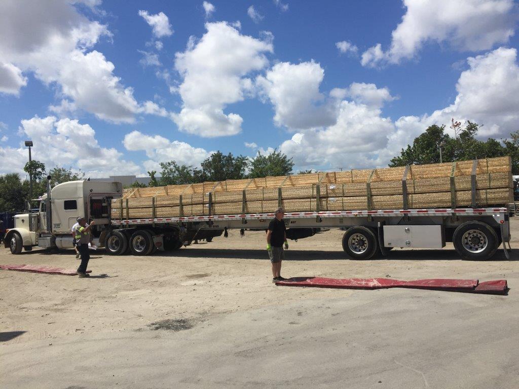 Workers And Truck With Planks — Miami, FL — J & M Scaffolds of Florida