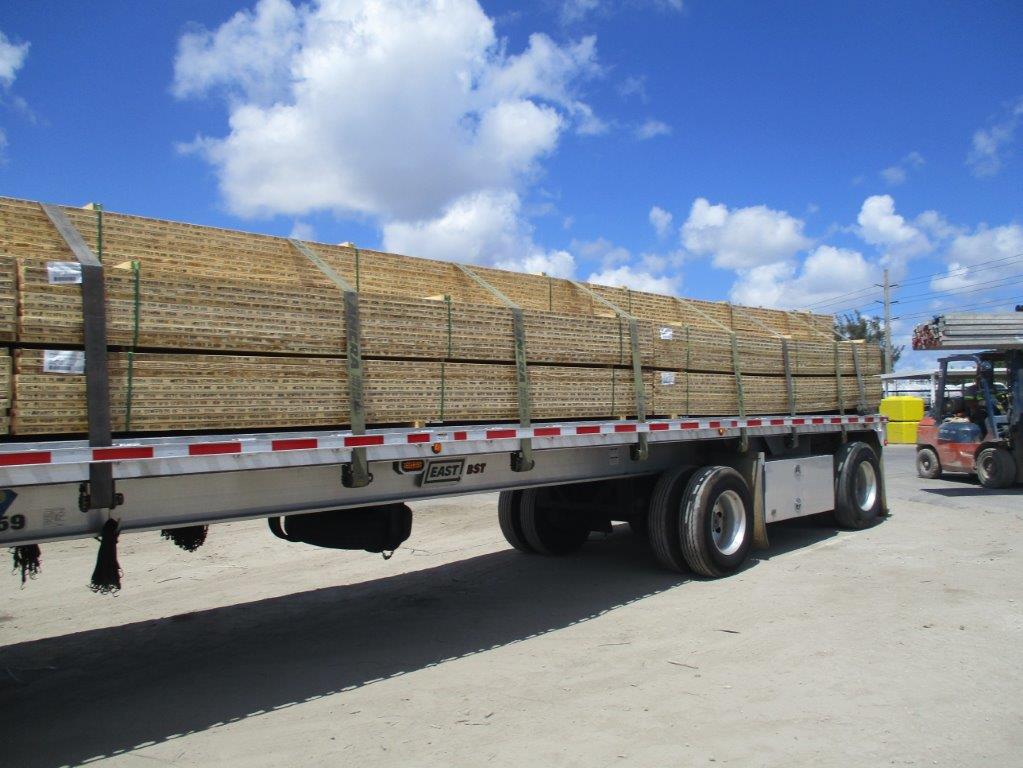 Pile Of Planks On Trailer Truck — Miami, FL — J & M Scaffolds of Florida