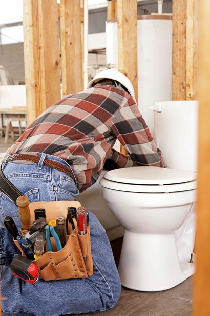 Plumber Installing a Toilet - Underground Pipe Service