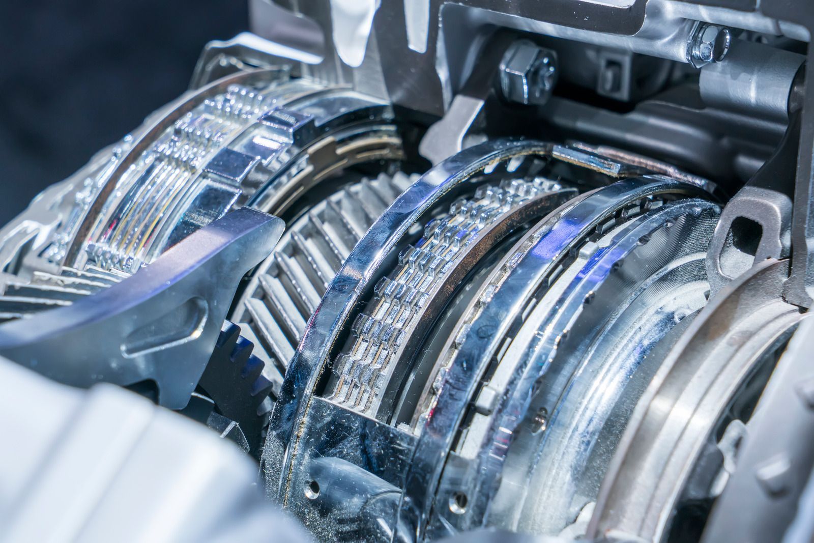 Close-up of a shiny industrial machine with metal gears and turbine-like components