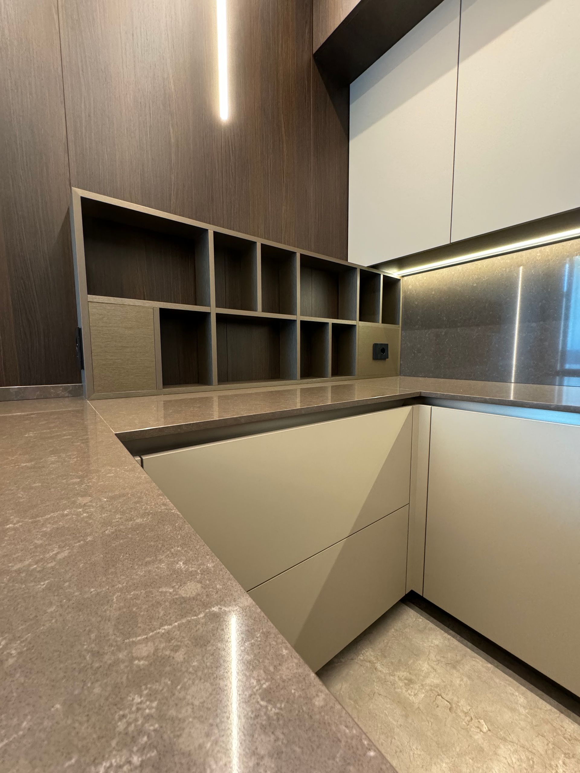 Una cucina con ripiano in marmo e mobili in acciaio inossidabile