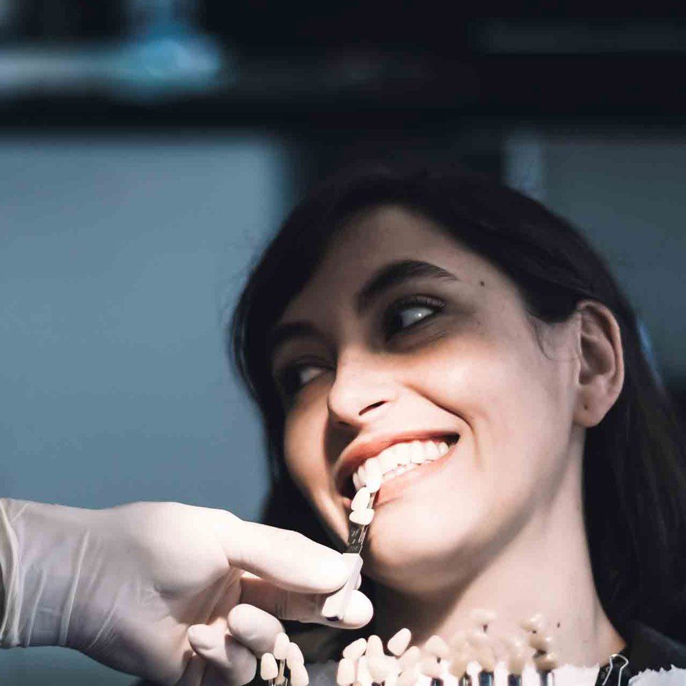 A Dentist Putting New Dentures — Portage, IN — Airport Road Dental Associates, PC