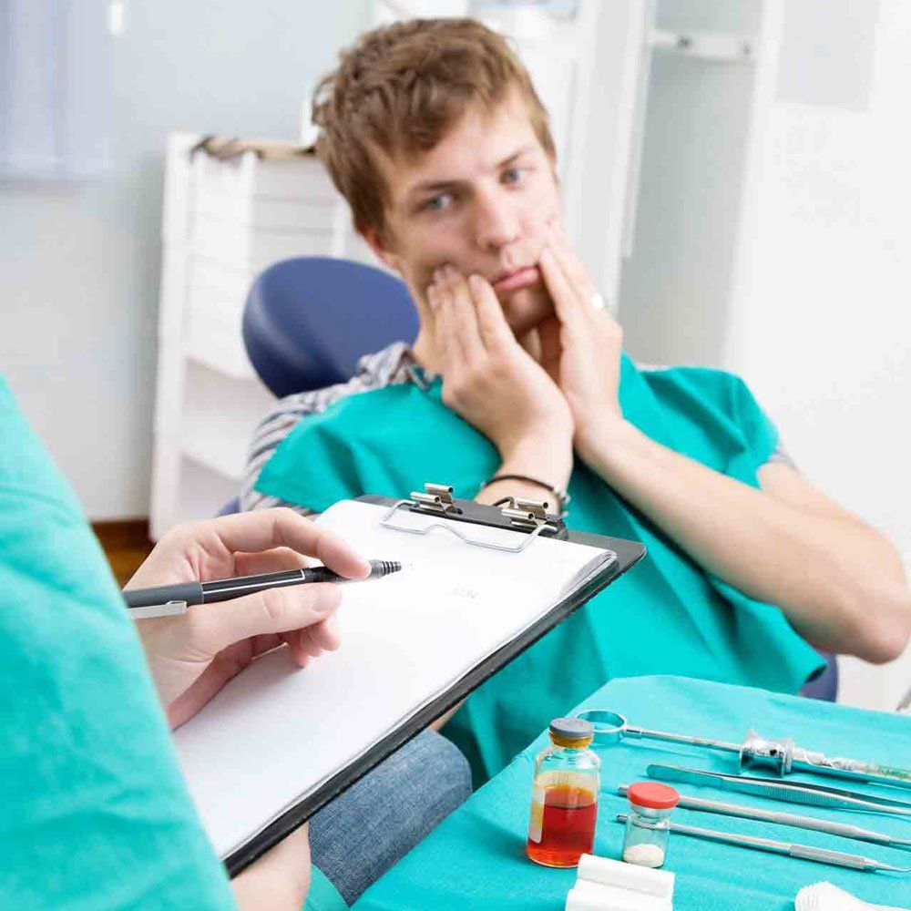 A Patient Having a Tooth Problem — Portage, IN — Airport Road Dental Associates, PC