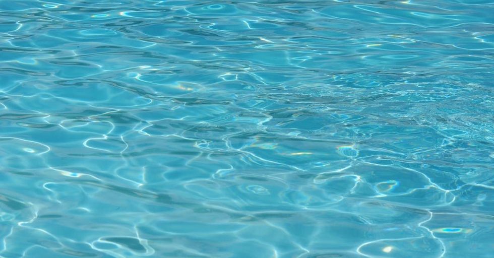 A close up of a swimming pool with blue water.