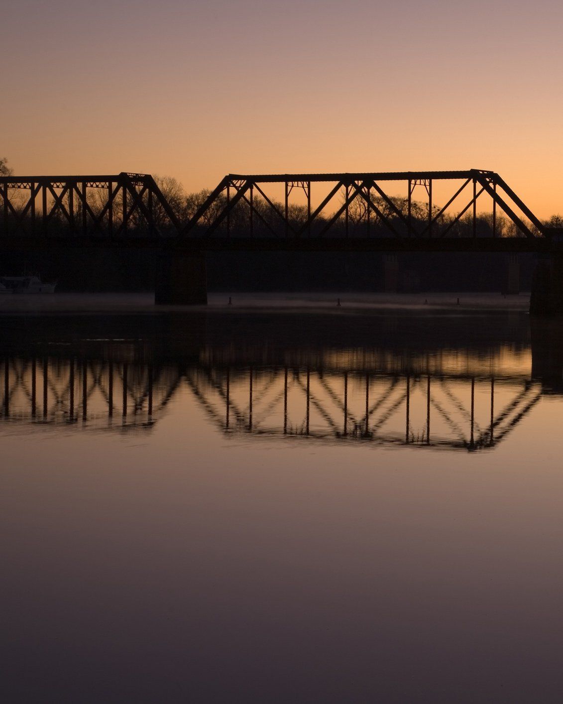 Sunset over river with bridge