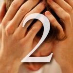 Person with hands covering face; number 2 overlaid.