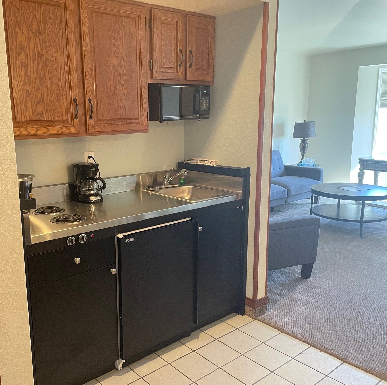 A kitchen with black cabinets and stainless steel counter tops