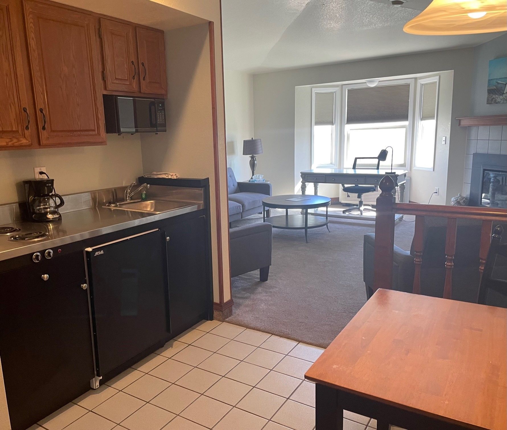 A kitchen with a table and a couch in the background