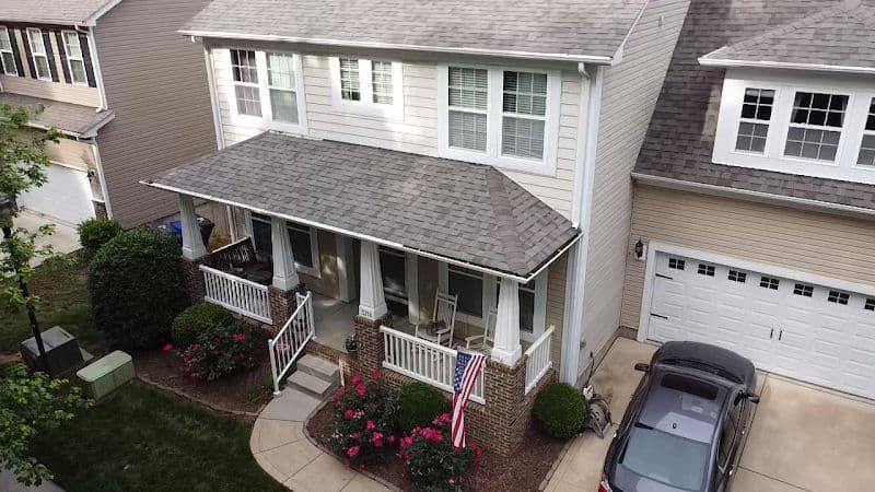 An aerial view of a house with a car parked in front of it.