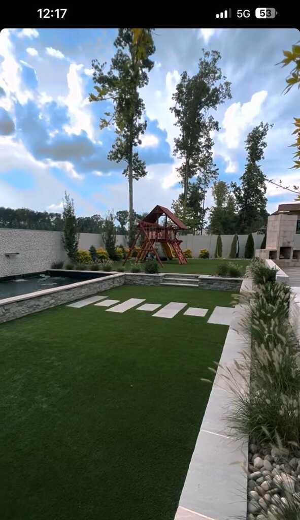 A phone screen shows a backyard with a playground and a swimming pool.