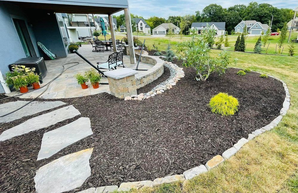 There is a patio with a fire pit in the backyard.