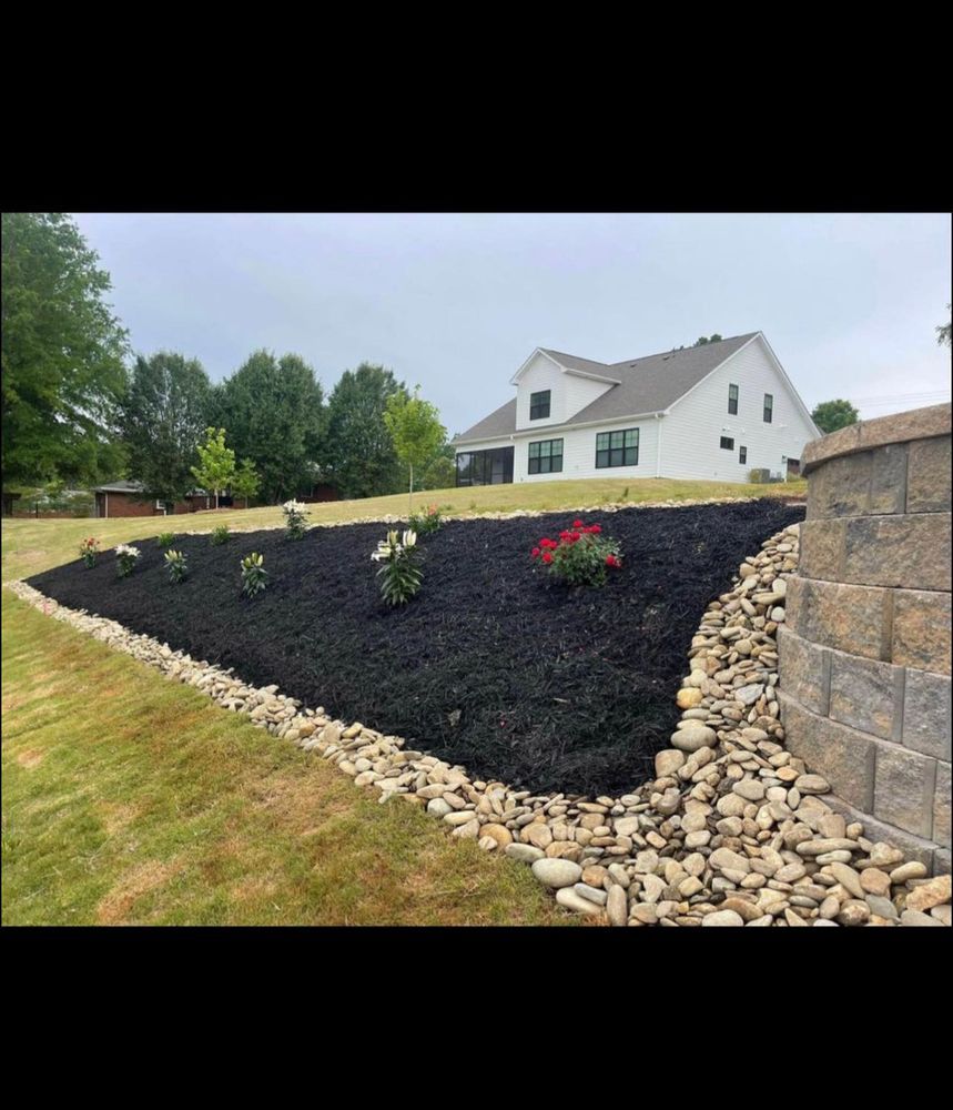 A large white house is sitting on top of a lush green hillside.