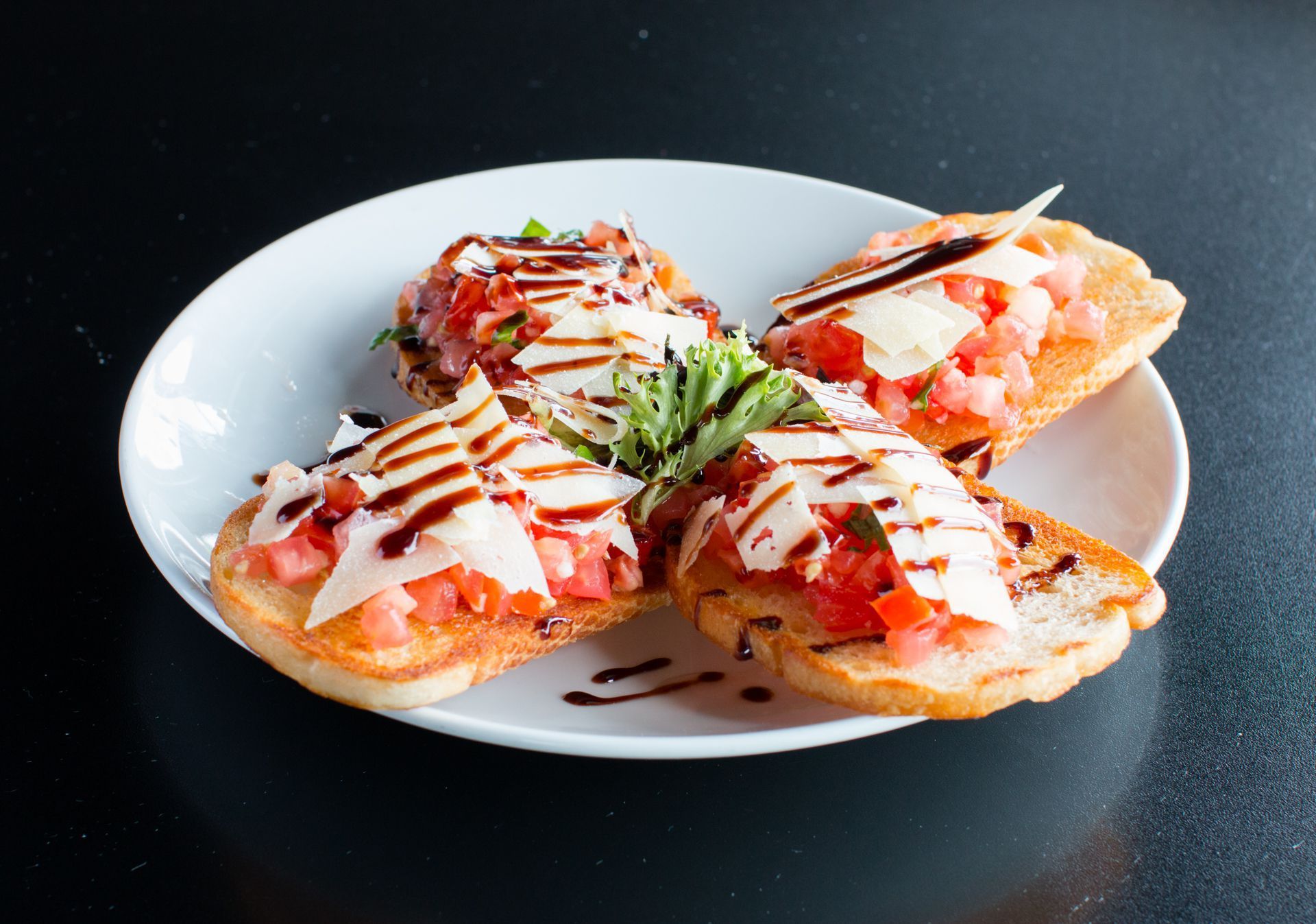 A plate of food with tomatoes and cheese on it.