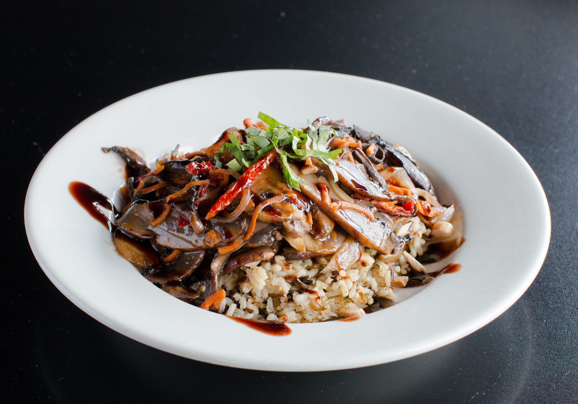 A white plate topped with mushrooms and rice.