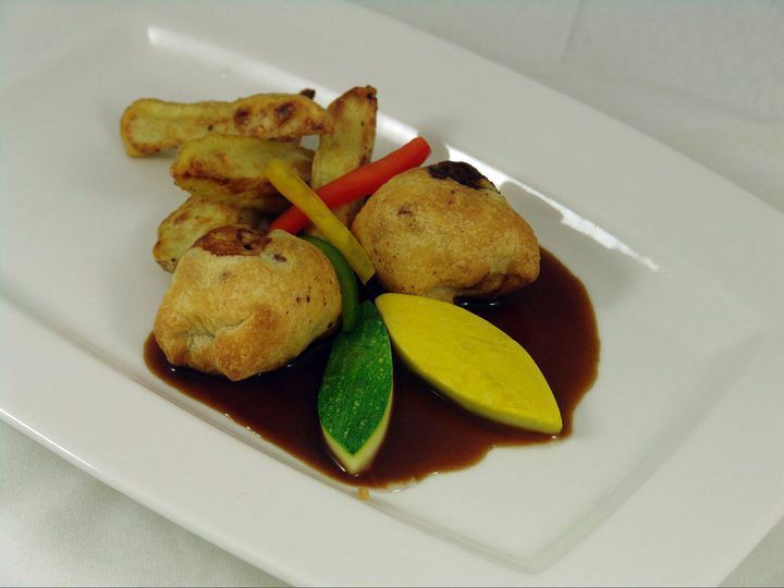 A plate of food with vegetables and sauce on it