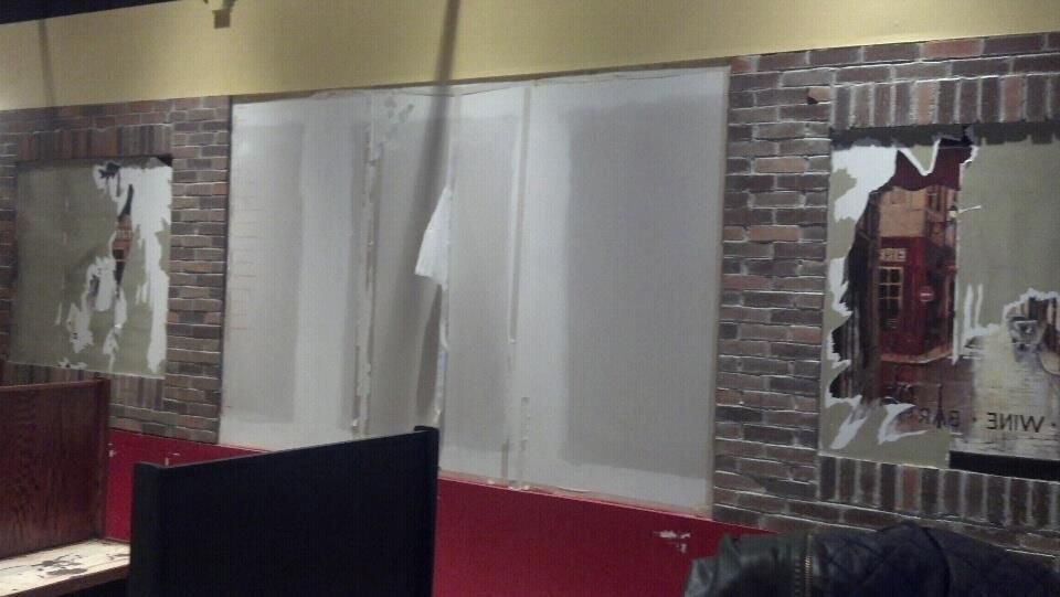 A room with a brick wall and white walls.