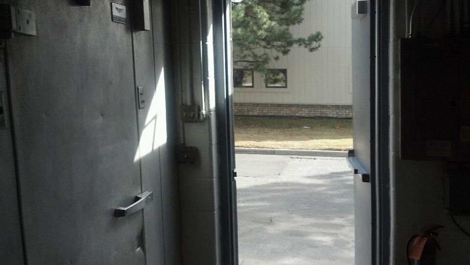 The door is open and looking out to a parking lot.