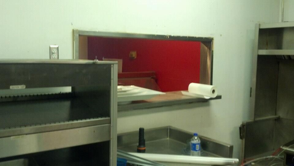 A kitchen with a bottle of aquafina water on the counter.