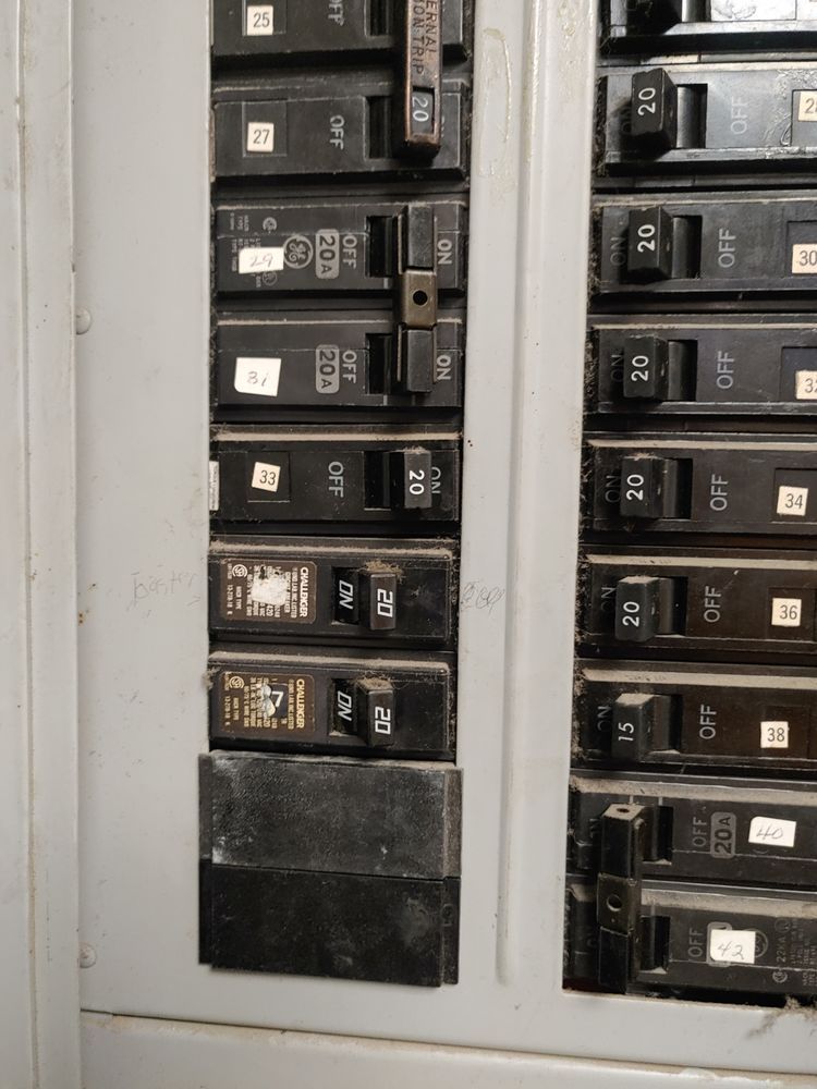 Electrical circuit breaker panel with switches in various positions.